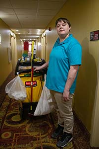 Person in hotel with cleaning cart