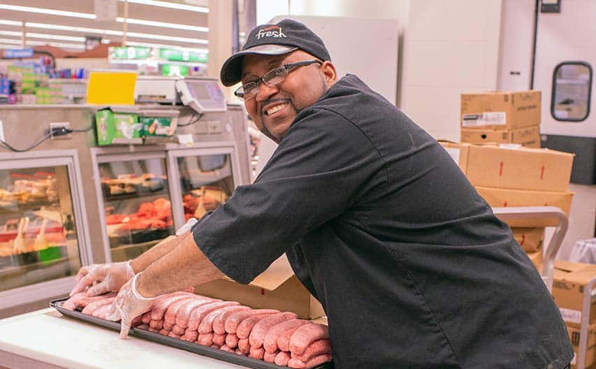 Person at work in grocery store meat department