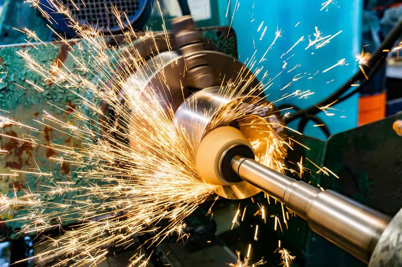 Grinding with an abrasive stone on a circular grinding machine with sparks.