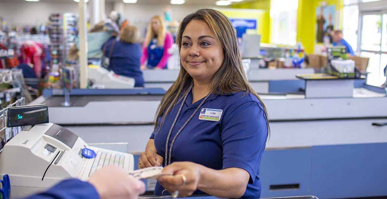 Goodwill cashier receiving voucher from customer