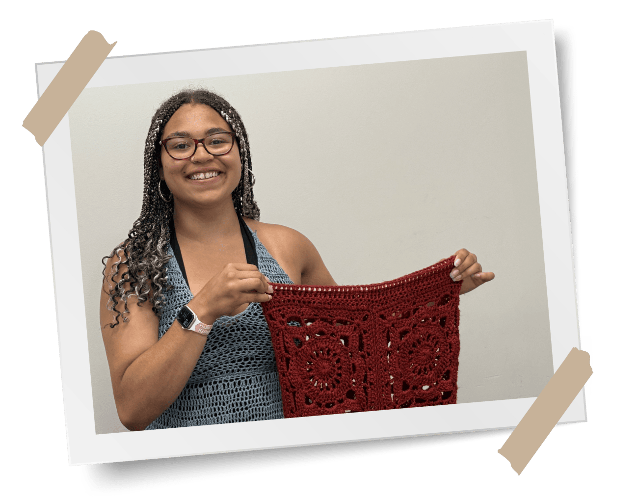 Youth Services participant Mara Bundy shows off a sample of her crochet work.