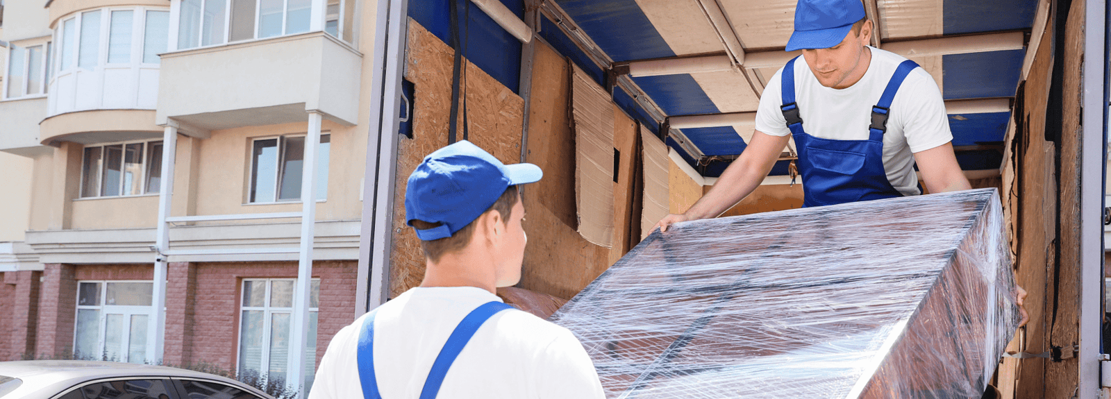 Crews load a Goodwill donation into the bed of a truck.