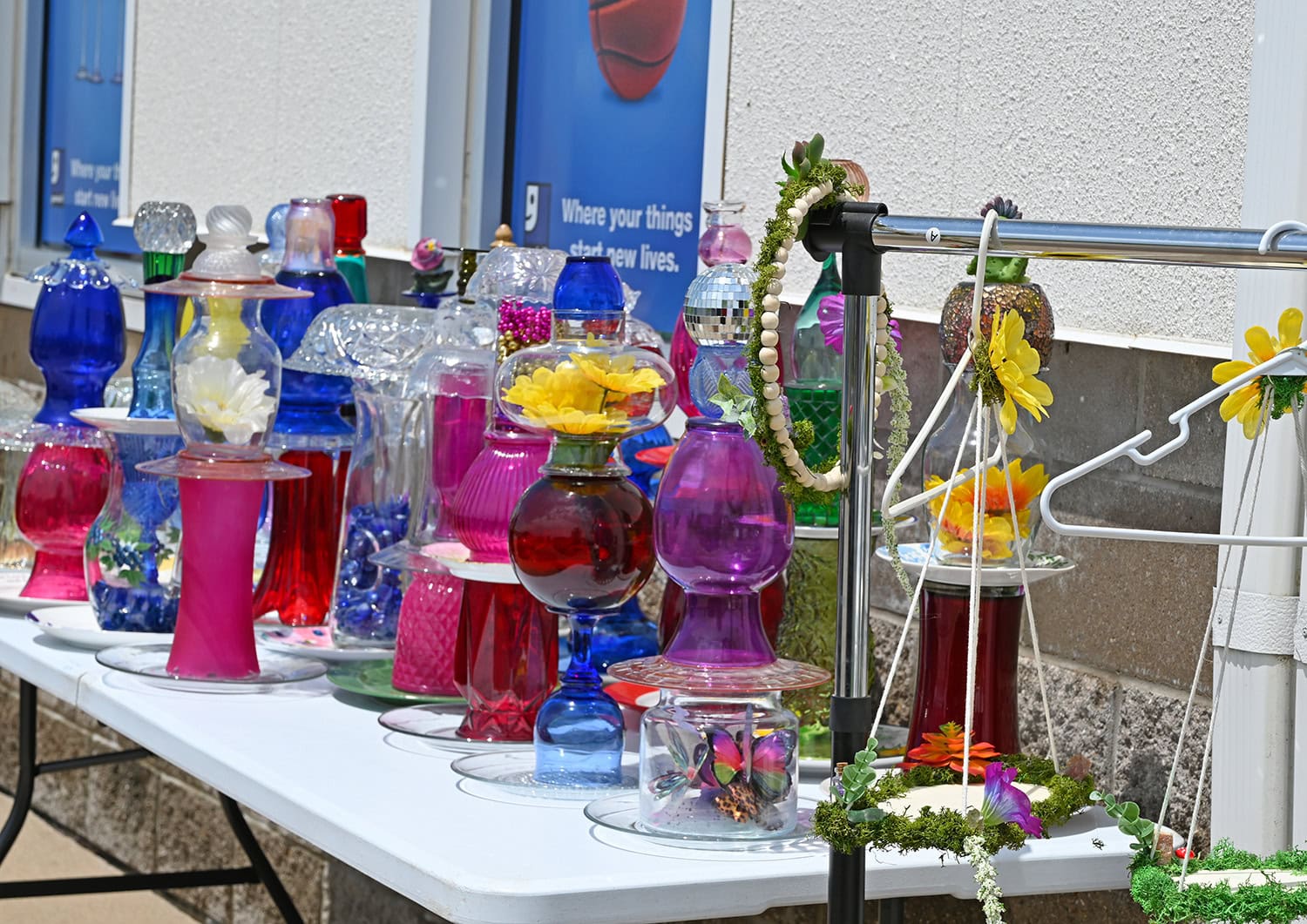 Glassware from Goodwill gets a new life as lawn ornamentation. Photo taken at the 2025 Re-Makers Market, Burlington Goodwill Store.